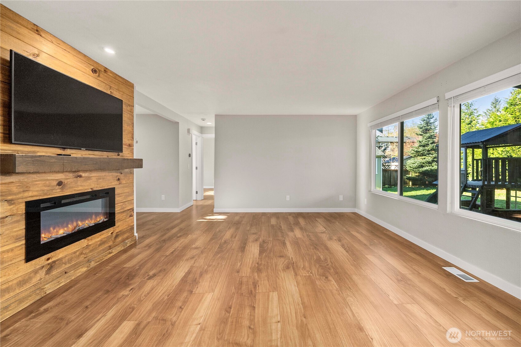 21816 Southeast 269th Street Maple Valley, WA 98038 - Photo 8 of 35 a view of empty room with fireplace and flat screen tv