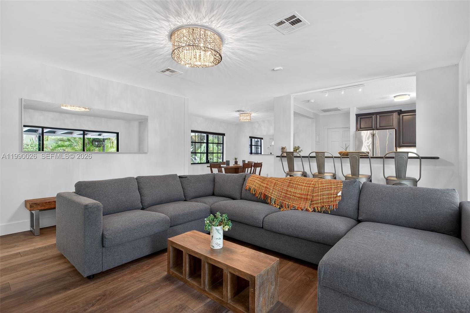 3401 Beacon Street Pompano Beach, FL 33062 - Photo 8 of 34 a living room with furniture kitchen and a chandelier