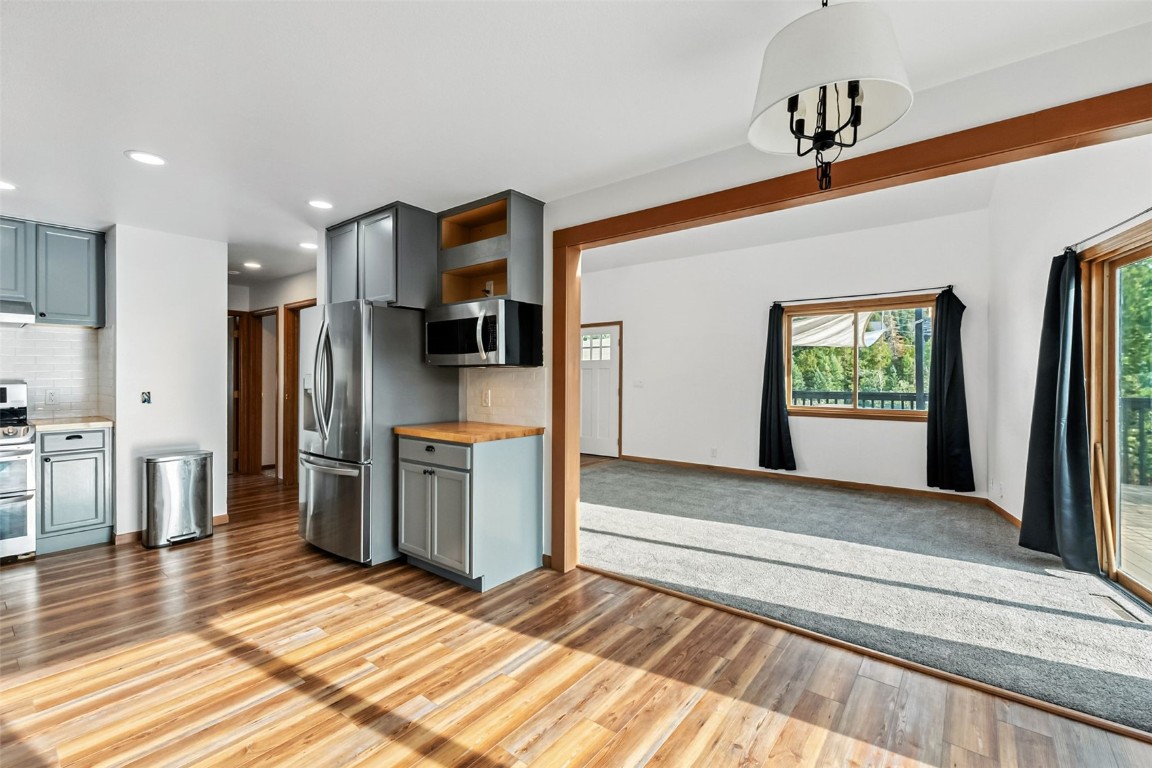 114 Big Elk Road Dillon, CO 80435 - Photo 18 of 50 a view of kitchen with stainless steel appliances kitchen island wooden floor and refrigerator