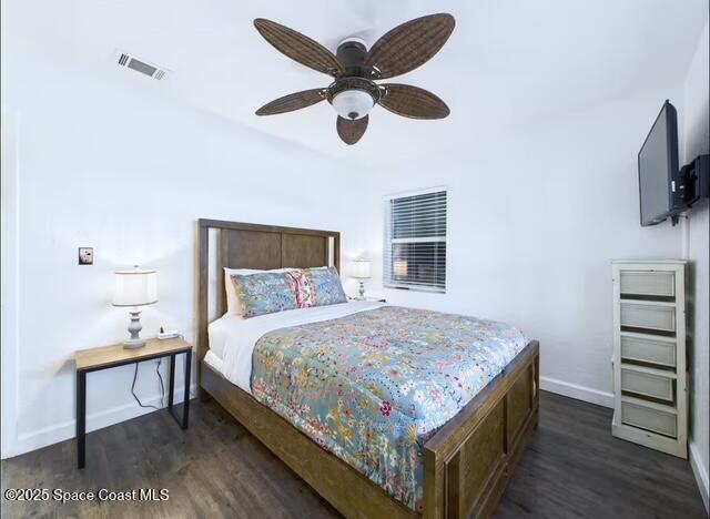 1747 Wavecrest Street Merritt Island, FL 32952 - Photo 14 of 21 a bedroom with a bed and a flat tv screen on dresser