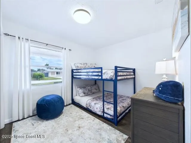 a bedroom with a bed window and dresser