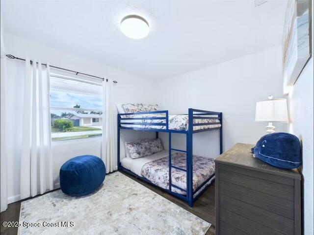 1747 Wavecrest Street Merritt Island, FL 32952 - Photo 16 of 21 a bedroom with a bed window and dresser