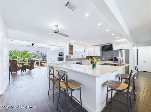 1747 Wavecrest Street Merritt Island, FL 32952 - Photo 5 of 21 a kitchen with a dining table chairs stove and cabinets
