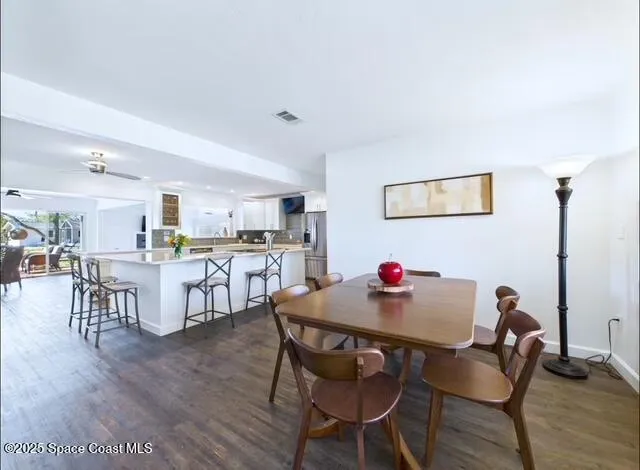 a dining room with furniture and wooden floor
