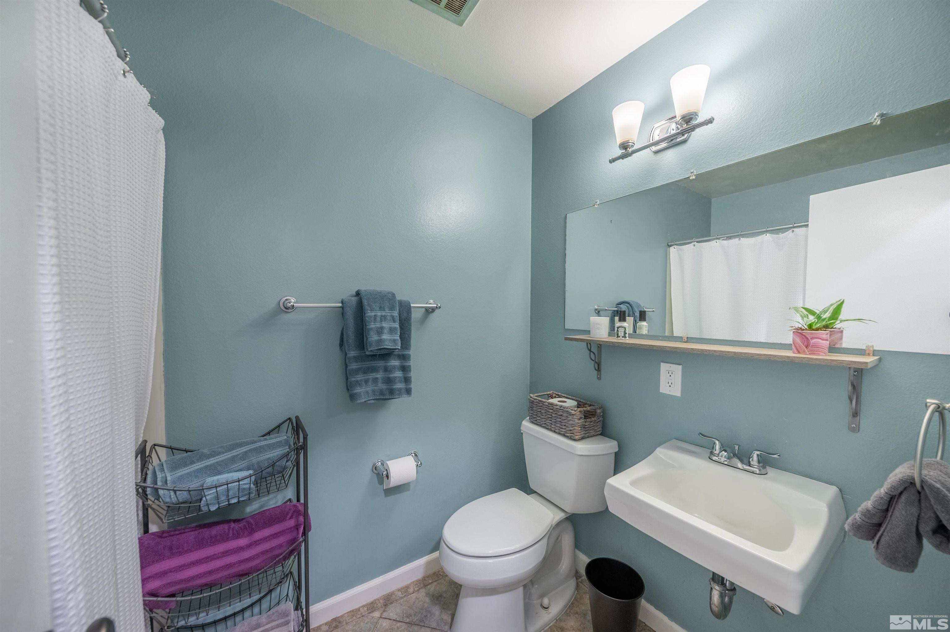 2926 Apollo Way Reno, NV 89503 - Photo 17 of 28 a bathroom with a sink toilet and a mirror