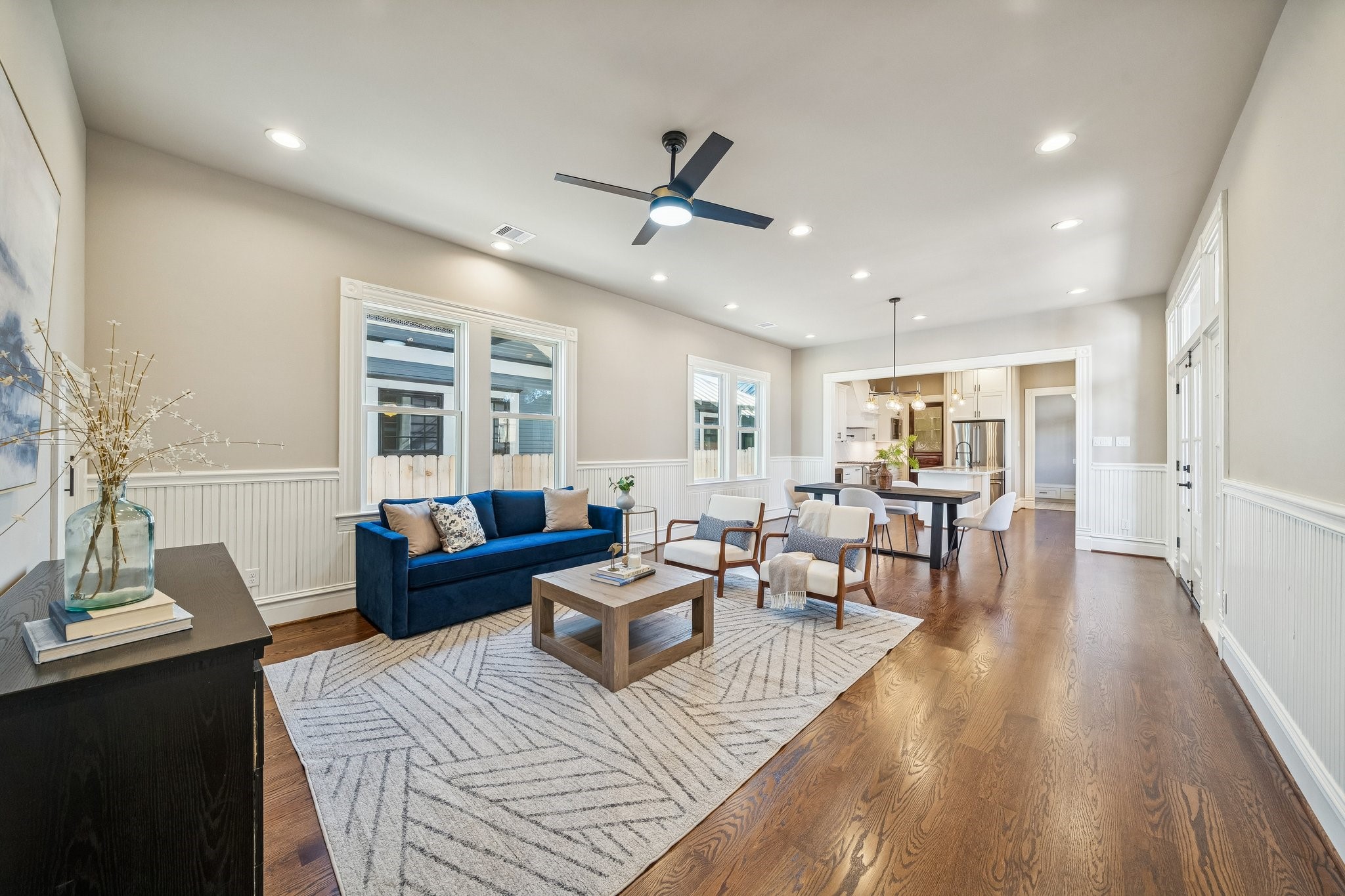 Open plan Living - Dining - Kitchen spaces! Note the wainscoting detail in this space. SOLID RED OAK hardwood floors throughout (no carpet in this home!). Plenty of windows letting in tons of natural light!