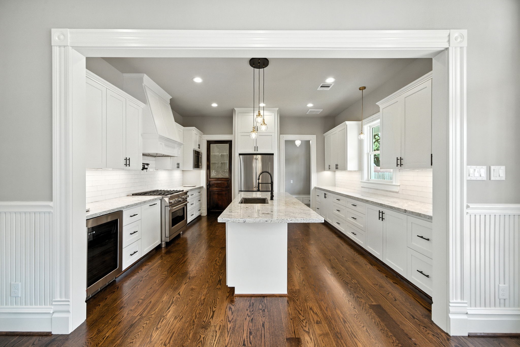 1521 Ovid Street Houston, TX 77007 - Photo 14 of 44 Custom built Shaker style cabinets. Granite counters. And a fabulous, historic door used as the pantry door (on the far left). Doorway on the right is entry / exit from carport, mudroom and half bath!