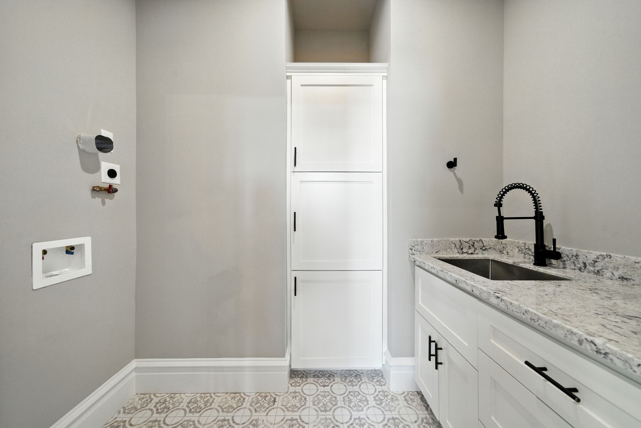 1521 Ovid Street Houston, TX 77007 - Photo 37 of 44 Utility room on the second floor with storage, stainless steel sink and granite counters / folding space! Stacking washer / dryer will go on the left