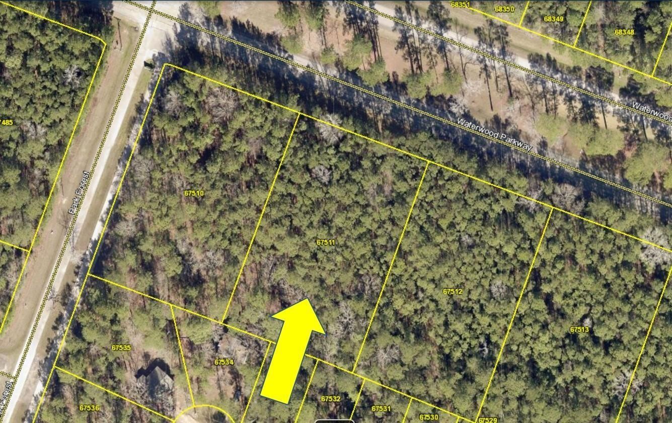 0 Waterwood Point Blank, TX 77364 - Photo 1 of 8 a view of a forest with a wall