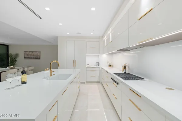 a view of a kitchen counter space a sink and living room view