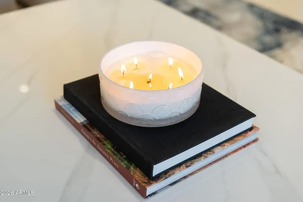 a living room with furniture a large window and a potted plant