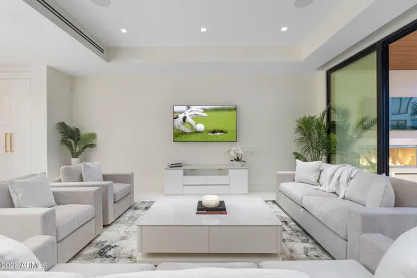 a bedroom with a large bed and a couch next to a window