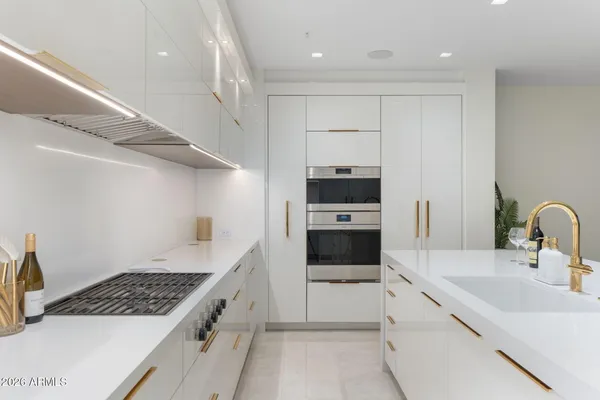 a spacious bedroom with a bed couch and a large window