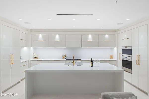 a view of a room with a sink and mirror