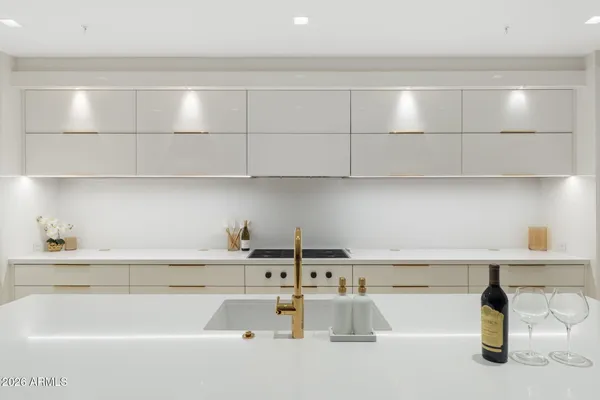 a kitchen with white cabinets a sink and appliances
