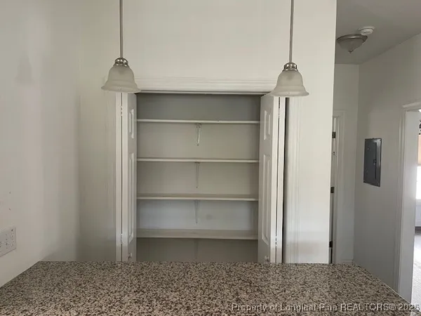 a room with a empty space and a ceiling fan