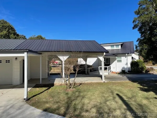 a view of a house with backyard porch and sitting area