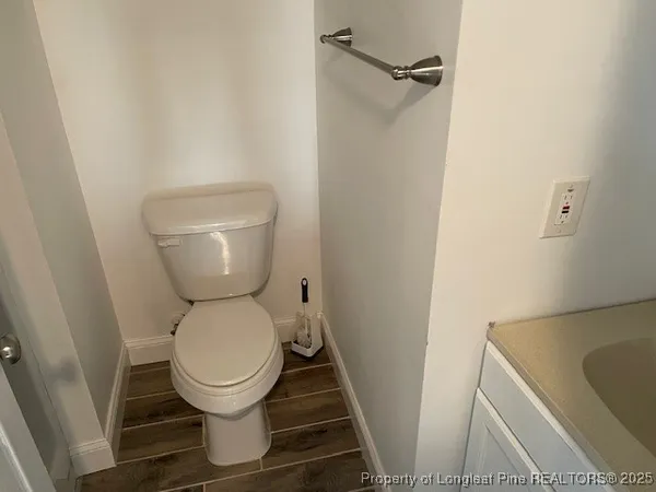 a white toilet sitting next to a sink