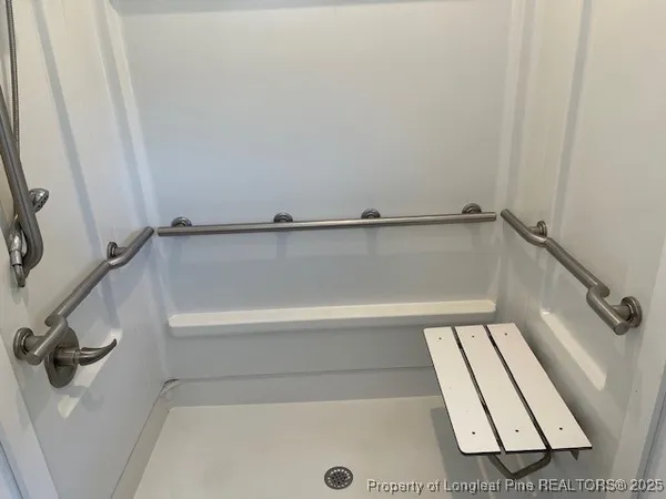 a view of bathroom with bathtub and shower