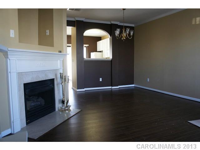 710 Shellstone Place, Unit 710 Fort Mill, SC 29708 - Photo 2 of 14 a view of a livingroom with wooden floor and a fireplace