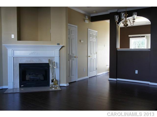 710 Shellstone Place, Unit 710 Fort Mill, SC 29708 - Photo 3 of 14 a view of an empty room with wooden floor and a fireplace