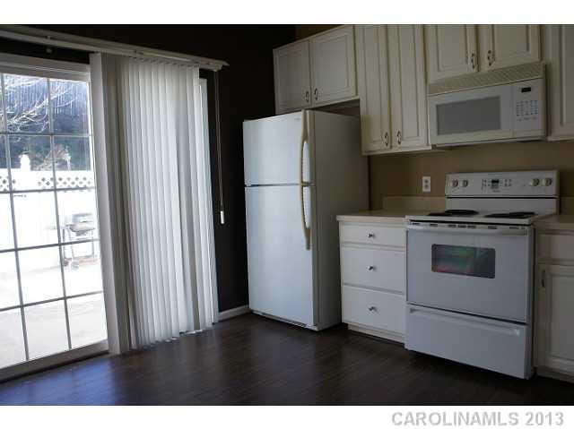 710 Shellstone Place, Unit 710 Fort Mill, SC 29708 - Photo 4 of 14 a kitchen with appliances a refrigerator a sink and cabinets
