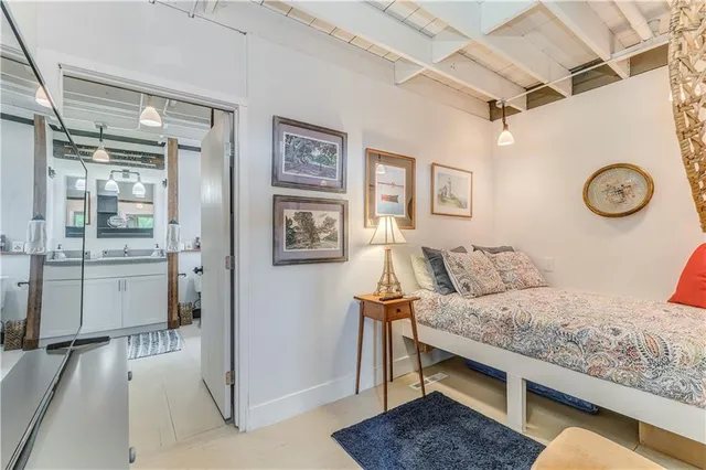 a bedroom with a bed and painting on the wall