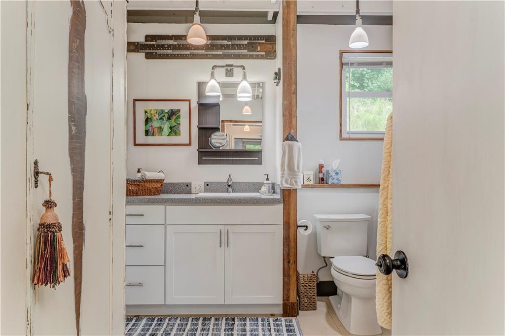 515 South Broad Street Rome, GA 30161 - Photo 15 of 26 a bathroom with a sink a toilet and a mirror