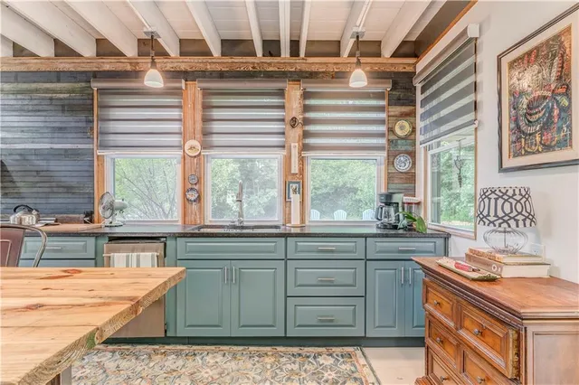 a kitchen with granite countertop a stove a sink and a cabinets