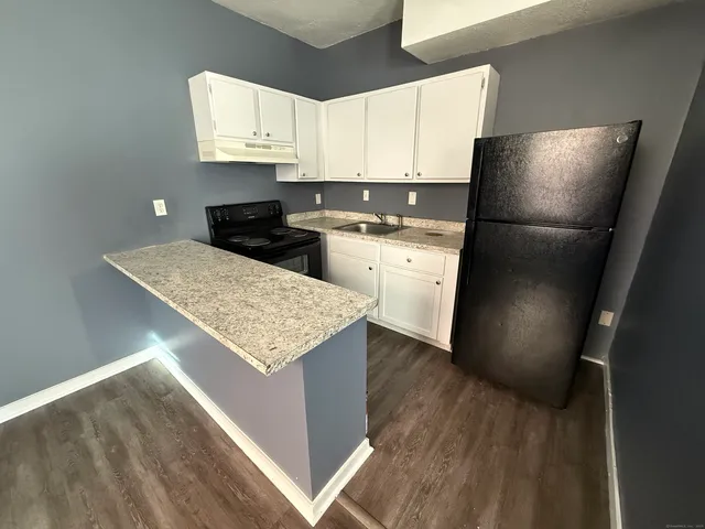 a kitchen with a refrigerator and a sink