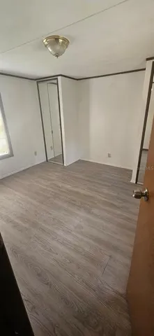 a view of a room with an empty space and a window