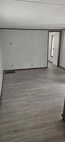 a white toilet sitting next to a white sink and vanity