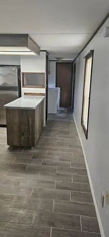 a view of a hallway with stairs and a window