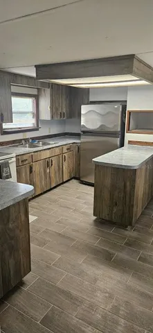 a kitchen with stainless steel appliances granite countertop a sink and a stove