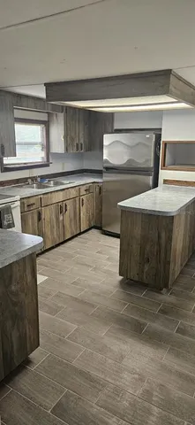 a kitchen with stainless steel appliances granite countertop a sink and a stove
