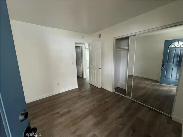 a kitchen with wooden floors and wooden cabinets