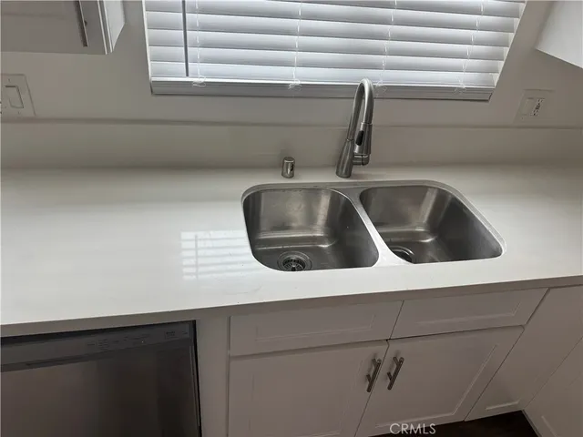 a kitchen with a refrigerator stove and wooden cabinets
