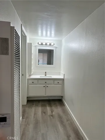 a view of a room with wooden floor