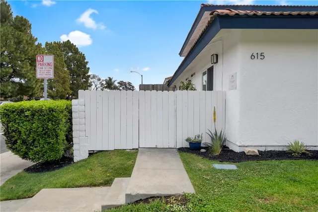 a view of an house with backyard space and tree