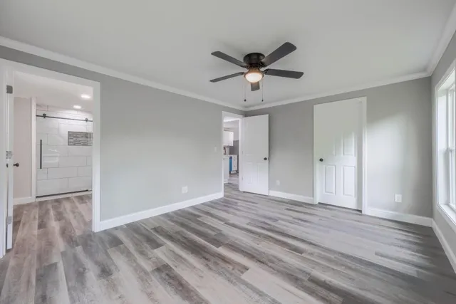 a view of an empty room and wooden floor