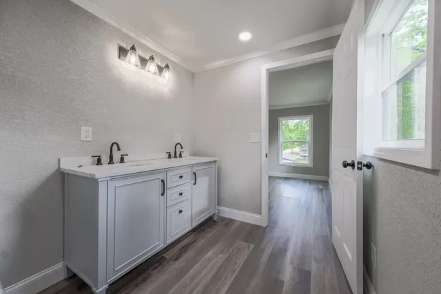 a spacious bathroom with a double vanity sink and mirror