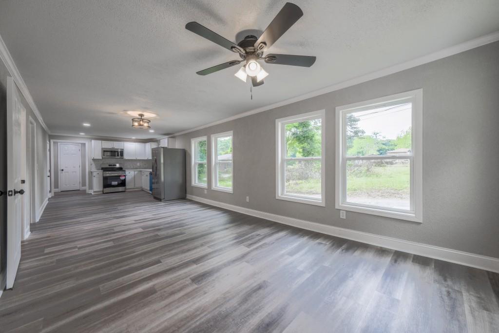 11 Cloverhurst Drive Toccoa, GA 30577 - Photo 4 of 26 a view of an empty room with a window and wooden floor