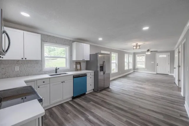a large kitchen with a lot of counter space and a wooden floors
