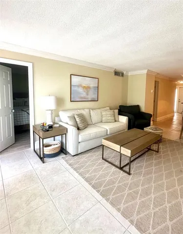 a living room with furniture and a rug