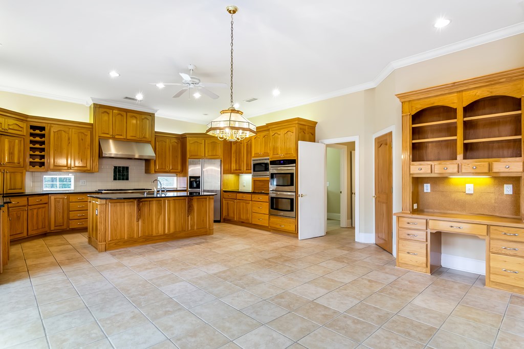 8010 Scudder Way Ball Ground, GA 30107 - Photo 13 of 57 a large kitchen with stainless steel appliances kitchen island granite countertop a refrigerator a oven and a sink
