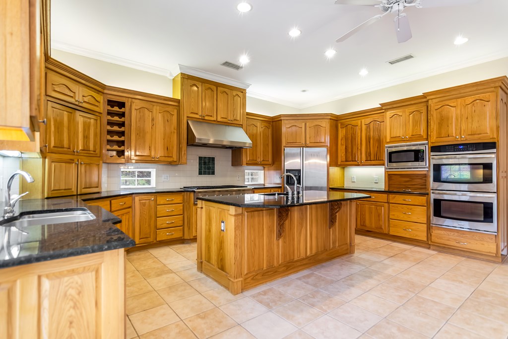 8010 Scudder Way Ball Ground, GA 30107 - Photo 15 of 57 a kitchen with stainless steel appliances granite countertop a stove sink and cabinets