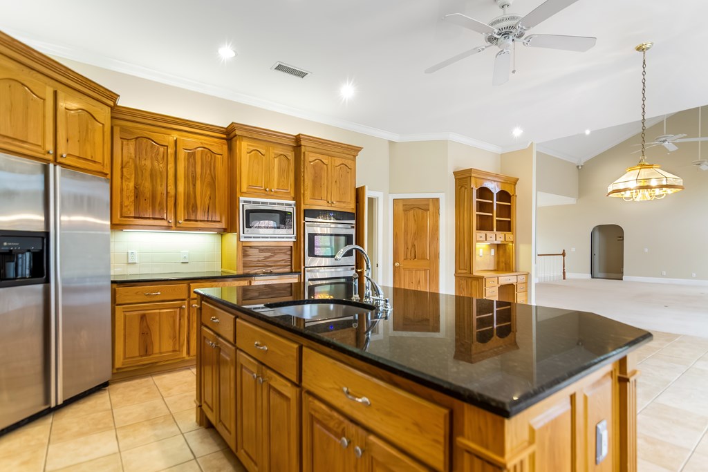 8010 Scudder Way Ball Ground, GA 30107 - Photo 16 of 57 a kitchen with stainless steel appliances granite countertop a sink refrigerator and cabinets