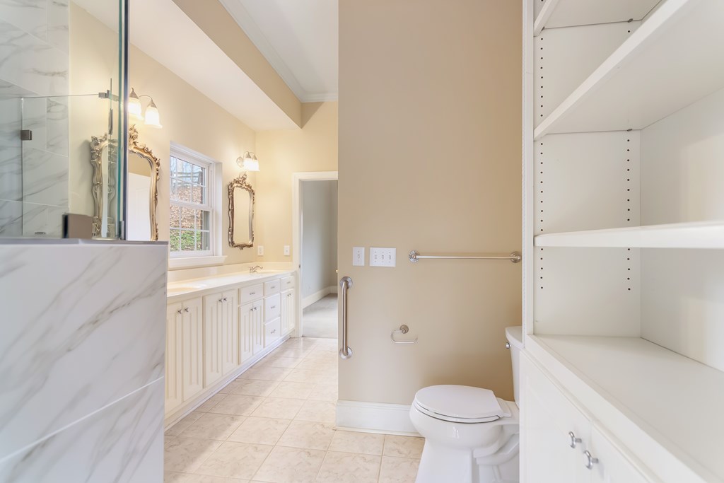 8010 Scudder Way Ball Ground, GA 30107 - Photo 19 of 57 a bathroom with a granite countertop sink toilet and shower