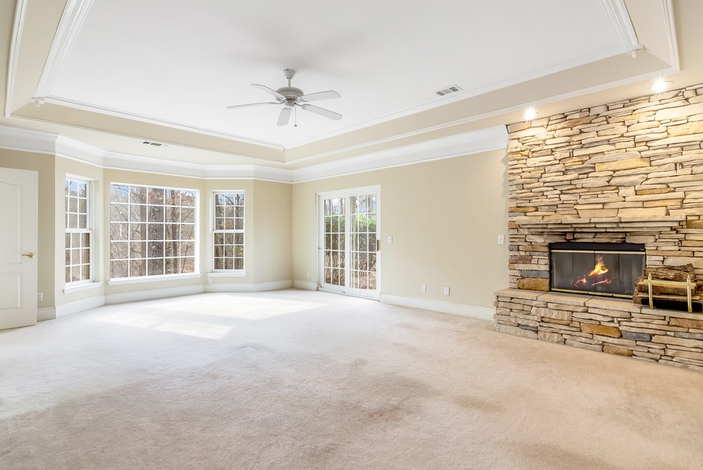 8010 Scudder Way Ball Ground, GA 30107 - Photo 21 of 57 a view of an empty room with a fireplace and a window