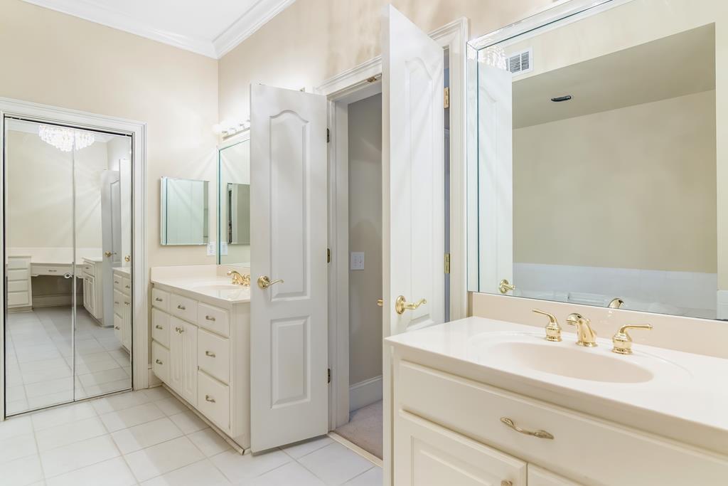 8010 Scudder Way Ball Ground, GA 30107 - Photo 23 of 57 a bathroom with a double vanity sink mirror and double